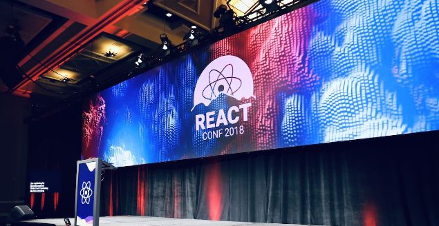 React conf 2018 showing a big poster of React with the words conf 2018 underneath as a backdrop.